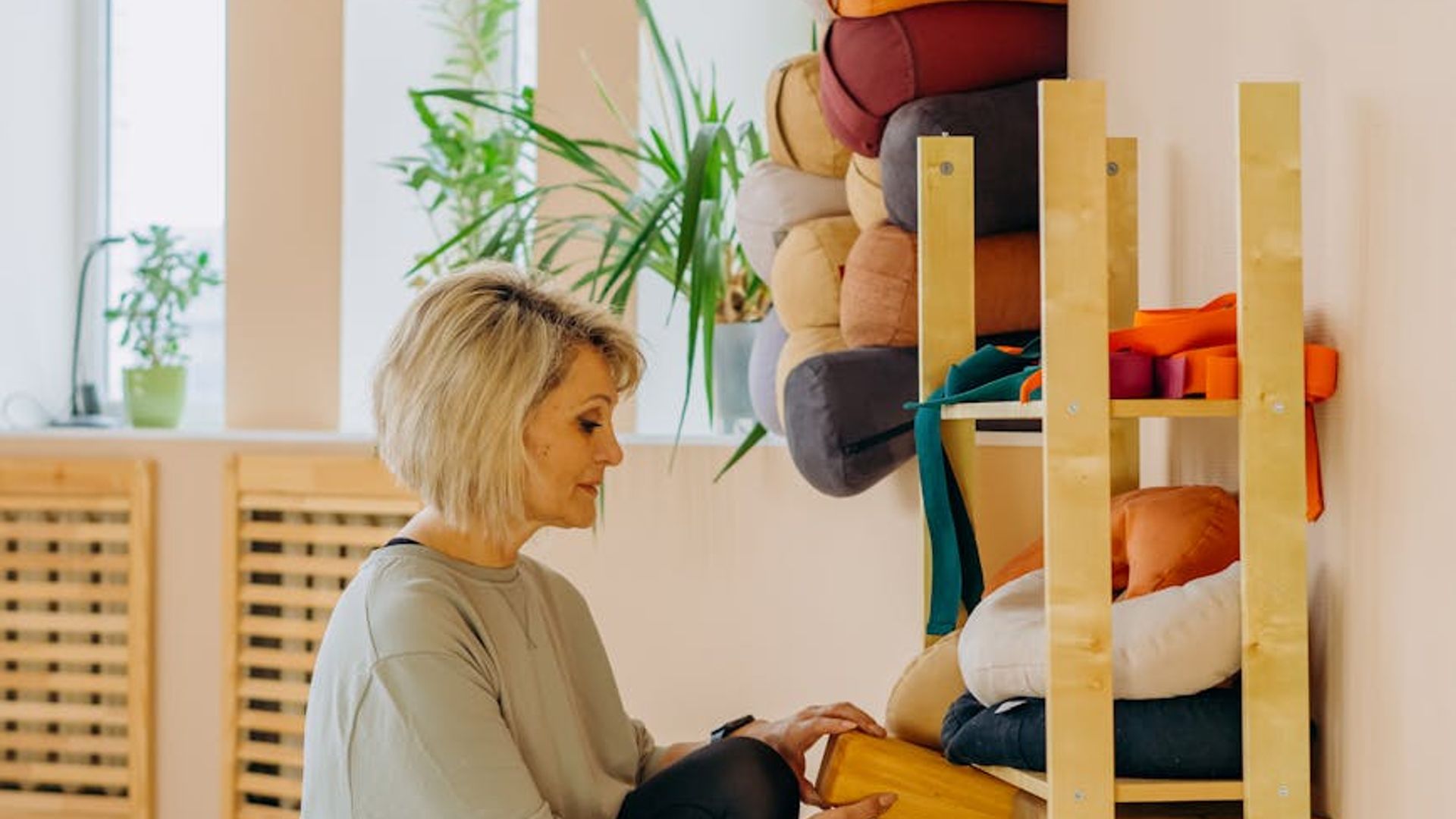 Atmospheric yoga studio with warm lighting and wooden floor