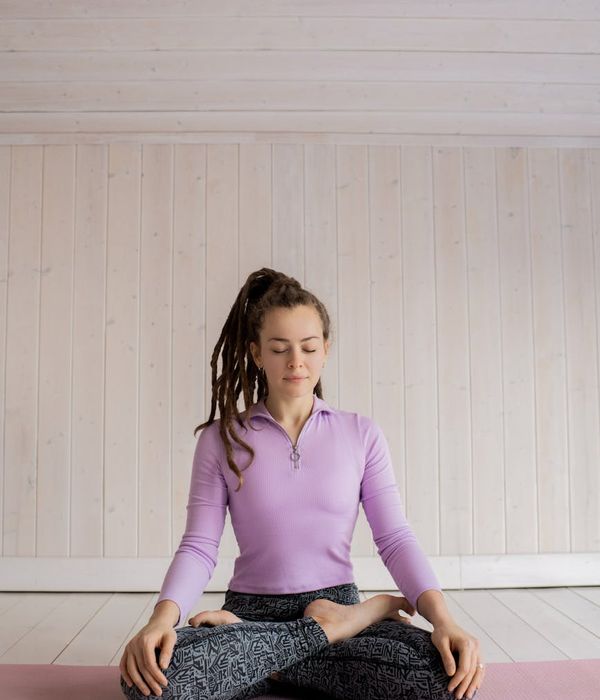 Person practicing yoga in a bright minimalistic room